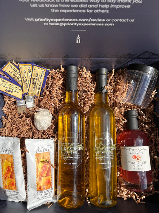olive oil bottles and snacks in a gift box with a custom messaging